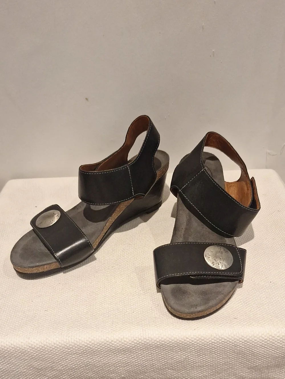 Taos Carousel 2 Black Leather Two-Strap Wedge Sandals With Silver Medalion